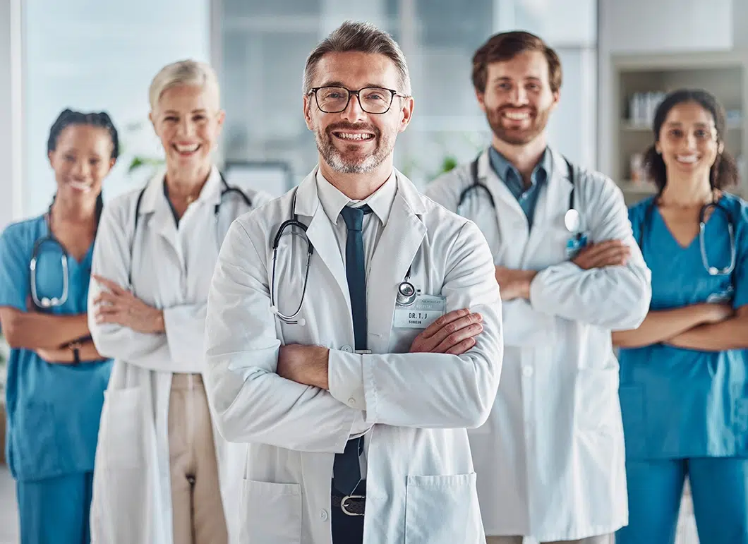 a group of people in white lab coats